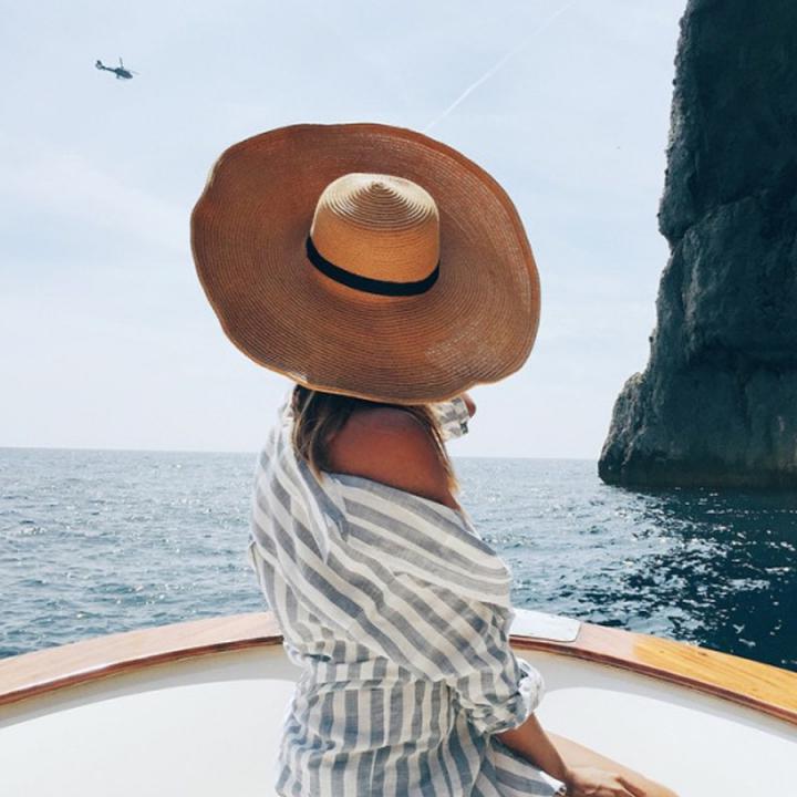 girl hat on boat