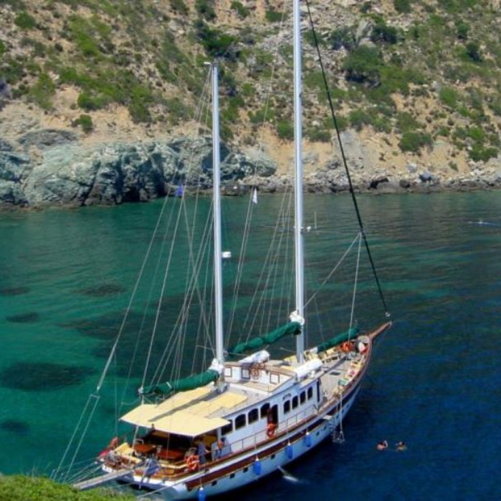 sailboat-anchored-in-calm-blue-sea-in-evia.jpg