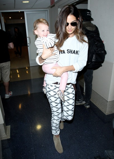 Lily Aldridge carries her daughter as they head for a flight from LAX