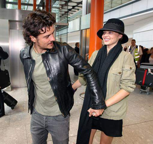 Orlando Bloom and wife Miranda Kerr arrive at heathrow airport