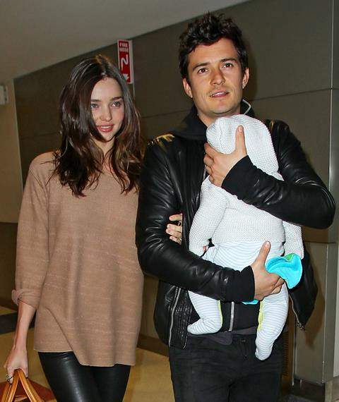 Orlando Bloom carries baby Flynn as they arrive in JFK Airport with Miranda Kerr in NYC