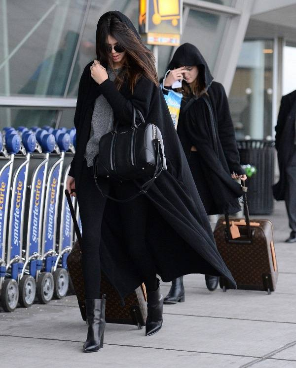 Kendall Jenner and Kylie Jenner were spotted arriving to JFK airport in NYC on Monday evening  The pair wore no makeup as they touched down  Kylie opted to wear no sunglasses while Kendall wore dark shades  as well as a long black cape  The sisters pulled