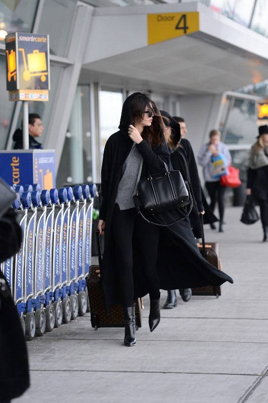 Kendall Jenner and Kylie Jenner were spotted arriving to JFK airport in NYC on Monday evening  The pair wore no makeup as they touched down  Kylie opted to wear no sunglasses while Kendall wore dark shades  as well as a long black cape  The sisters pulled