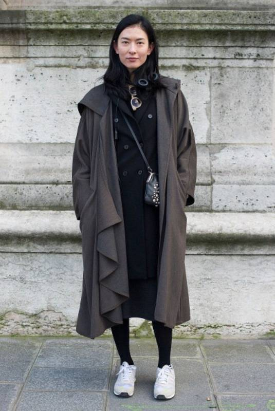 PARIS FRANCE - FEBRUARY 26 Hsin Yu poses wearing a Zara coat and Adidas trainers before Yang Li show on Day 2 of Paris Collections Womenswear Fall Winter 2014-2015 at Palais des Beaux Arts on February 26 2014 in Paris France Photo by Vanni Bassett