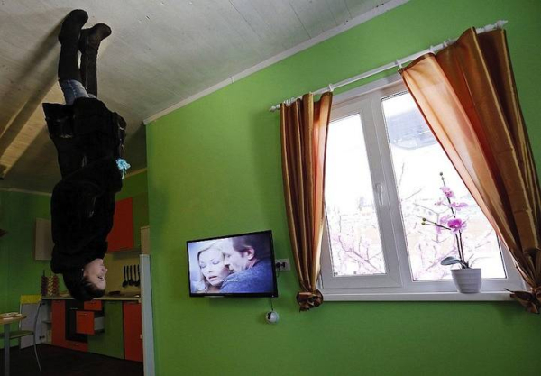 A woman visits a room in a house built upside-down in Russia s Siberian city of Krasnoyarsk
