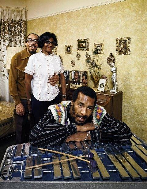Richie Havens leaning on a xylophone with parents Richard and Mildred in the background in their home in East Flatbush  Brooklyn  New York