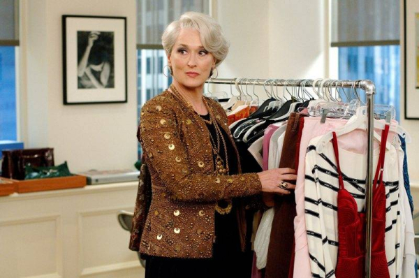 Scenes from The Devil Wears Prada  P Pictured  Miranda Priestly  Meryl Streep  wears a bead detailed Bill Bass jacket  a silk dress by Bill Blass accented with a green reptile Roberto Cavalli belt with snake resin buckle  gold chandelier necklace coupled 