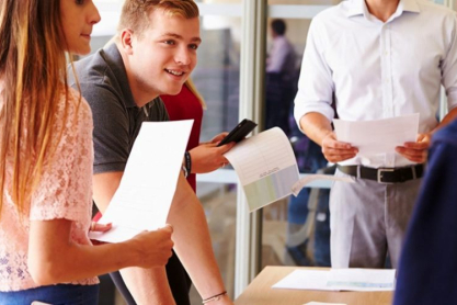 photodune-11189445-teacher-with-college-students-standing-by-desks-in-classroom-l-960x500.jpg