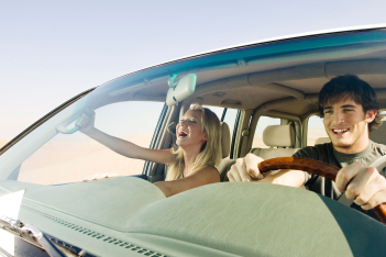 young-couple-driving-in-desert.jpg
